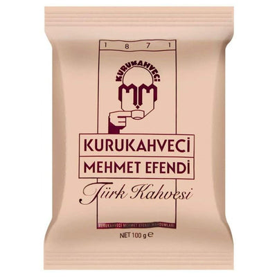 A beige 100g pack of Kurukahveci Mehmet Efendi Turkish Coffee, displaying the brand logo and product name—ideal for fans of traditional coffee.