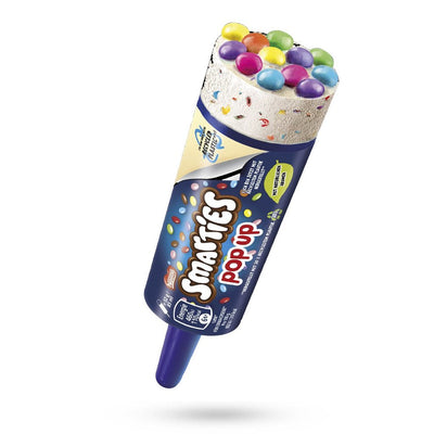 An 85ml Smarties Pop Up Ice Cream by Nestle, featuring creamy ice cream with colourful Smarties candy on top in a blue push-up tube labeled “Smarties Pop Up,” shown against a white background.