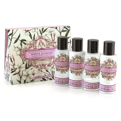 The Summerset Toiletry - Rose Petal Travel Toiletry Gift Set features four travel-size essentials—shampoo, conditioner, body wash, and body cream—elegantly boxed with floral packaging. An ideal luxury gift for any trip.